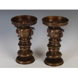 A pair of large Japanese Meiji period bronze sectional vases and stands, the wide flared necks