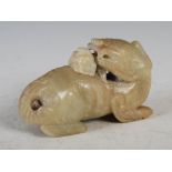 A Chinese pale celadon jade incense burner in the form of a Shishi dog, with detachable cover,