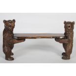 A late 19th / early 20th century Black Forest carved spruce/ pine bench, the seat carved in