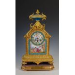 A late 19th century French gilt bronze and porcelain mounted mantel clock, the case of arched form