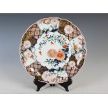 A late 19th century Japanese Imari bowl, of round lobed form with a wide border of floral and