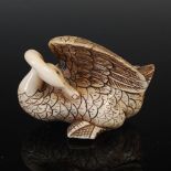A Japanese carved ivory netsuke, probably Meiji Period, depicting a preening swan, two character
