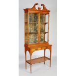 An early 20th century satinwood and ebony strung vitrine cabinet, in the manner of Maple & Co, the