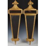 A pair of 19th century giltwood wall mirrors, of tapering narrow form with a top acanthus finial