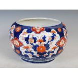 A late 19th century Japanese Imari bowl, decorated with scenes of flowers in red and blue surrounded