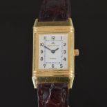 An 18ct gold ladies Jaeger-Le Coultre Reverso wristwatch, the rectangular silvered dial with black