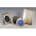 Four 20th century silver photograph frames, including two oval examples, a serpentine rectangular