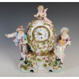 An early 20th century Dresden porcelain figural mantel clock, the case of balloon form decorated