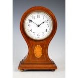 An early 20th century mahogany and marquetry mantel clock, of balloon form on a square plinth base