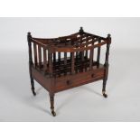 A 19th century rosewood canterbury, the four turned supports with toupee finials, the four