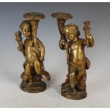 A pair of late 19th century French gilt bronze candlesticks after Clodion, modelled as Cupid / putti