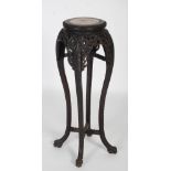A late 19th / early 20th century Chinese carved darkwood tall jardiniere stand, the round white