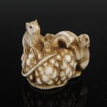 A Japanese carved ivory netsuke, possibly Edo period, depicting two rats on a pumpkin, two character