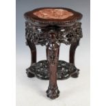 A small Chinese dark wood stand, Qing Dynasty, the shaped hexagonal top with a mottled red and white