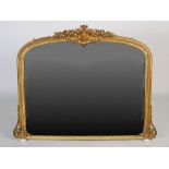 A Victorian gilt gesso overmantel mirror, the rectangular arched plate within a moulded strapwork
