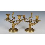 A pair of late 19th / early 20th century French gilt bronze two branch candelabra, in the Louis XV