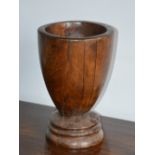 An 18th/ 19th century turned fruit wood urn-shaped vessel, on stepped cylindrical plinth, 39cm
