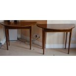 A pair of 19th century mahogany and boxwood lined demi-lune console tables, the shaped tops above