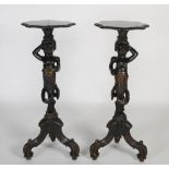 A pair of late 19th / early 20th century ebonised carved wooden blackamoor figures, probably