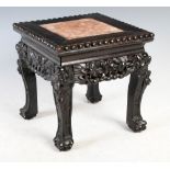 A small Chinese dark wood stand, Qing Dynasty, the square top with a mottled red and white marble