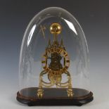A Victorian Gothic brass skeleton clock, the openwork pointed arch gothic case on four bun feet