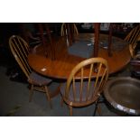 SET OF FOUR ERCOL BLONDE WOOD SPINDLE BACK DINING CHAIRS, TOGETHER WITH A CIRCULAR PEDESTAL DINING