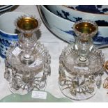 A PAIR OF 19TH CENTURY CUT GLASS LUSTRE CANDLE STANDS WITH GILT METAL SCONCES SUSPENDING FACET-CUT