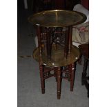 TWO MOORISH BRASS TOPPED OCCASIONAL TABLES ON FOLDING BASES.