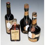 FOUR VINTAGE BOTTLES OF LIQUEURS TO INCLUDE TWO DOM BENEDICTINE, ONE CHERRY HERRING, AND ONE