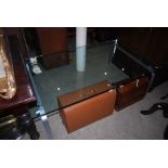CONTEMPORARY PLATE GLASS COFFEE TABLE ON SILVERED END SUPPORTS.