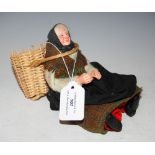 SCOTTISH DOLL MODELLED AS A FISHWIFE WITH WOVEN WICKER CREEL, TWEED SCARF, KNITTED JUMPER.