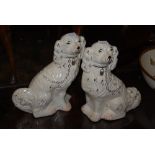 A PAIR OF STAFFORDSHIRE POTTERY DOGS