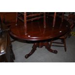 VICTORIAN MAHOGANY OVAL PEDESTAL DINING TABLE ON THREE DOWNSWEPT SUPPORTS.