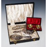 A CASED SILVER BACKED FOUR PIECE DRESSING TABLE SET, TOGETHER WITH CASED PAIR OF BIRMINGHAM SILVER