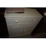 A CREAM PAINTED PINE CHEST OF TWO DRAWERS OVER TWO CUPBOARD DOORS BELOW