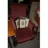 A 19TH CENTURY MAHOGANY VELVET UPHOLSTERED ARMCHAIR ON TAPERED CYLINDRICAL SUPPORTS, BRASS CUPS