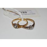 TWO YELLOW AND WHITE METAL MOUNTED SINGLE STONE DIAMOND RINGS, ONE SET WITH A SINGLE OLD CUT DIAMOND