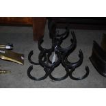 SIX BOTTLE WINE RACK FORMED FROM HORSESHOES.
