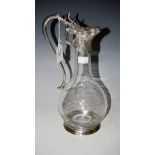 A MODERN WHITE METAL MOUNTED CLEAR GLASS CLARET JUG, THE COVER IN THE FORM OF A HINGED STAGS HEAD.