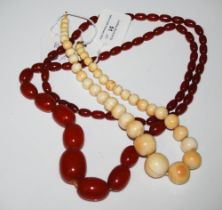 GRADUATED RED AMBER TYPE BEAD NECKLACE, 86.3 GRAMS, TOGETHER WITH ANOTHER GRADUATED BEAD NECKLACE.