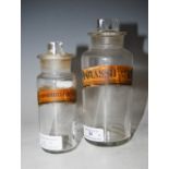 TWO CLEAR GLASS APOTHECARY JARS AND STOPPERS