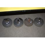 FOUR ASSORTED GRANITE CURLING STONES.