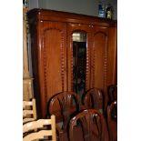 A VICTORIAN MAHOGANY THREE DOOR WARDROBE, THE CENTRAL DOOR WITH MIRROR PLATE