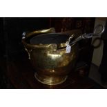 A BRASS HELMET SHAPED COAL SCUTTLE CONTAINING ASSORTED FIRE IRONS AND A CAST METAL BOOT JACK