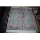 A PAIR OF CHINESE GREEN GROUND FIRESIDE RUGS TOGETHER WITH TWO CHINESE PINK GROUND RUGS OF