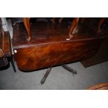 A 19TH CENTURY MAHOGANY DROP-LEAF PEDESTAL TABLE WITH SINGLE END DRAWER ON FOUR DOWNSWEPT SUPPORTS