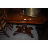 A 19TH CENTURY ROSEWOOD PEDESTAL GAMES TABLE ON CONCAVE PLATFORM BASE WITH FOUR PAW FEET.