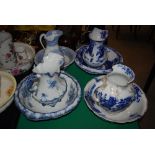 FOUR ASSORTED 19TH CENTURY AND LATER BLUE PRINTED EWER AND BASIN SETS.