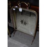 ART NOUVEAU BRASS FIRE GUARD WITH BEVELLED MIRROR INSERT.