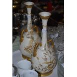 PAIR OF LATE 19TH CENTURY ROYAL WORCESTER IVORY GROUND TWIN-HANDLED BOTTLE VASES.
